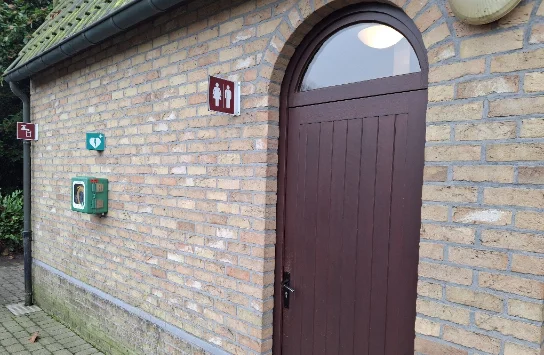 AED Building to the right of the entrance to the cemetery